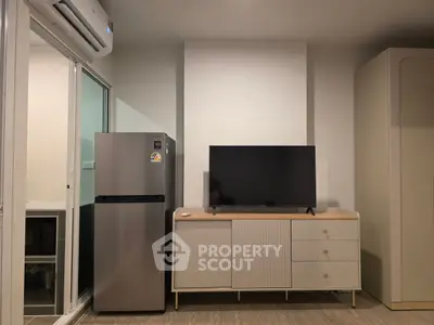 Modern living room with sleek TV stand and stainless steel fridge