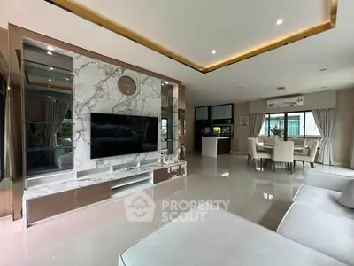 Luxurious modern living room with marble accents and open dining area, perfect for stylish entertaining.