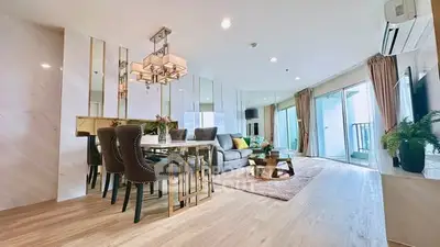 Luxurious open-plan living room with elegant dining area and modern decor.