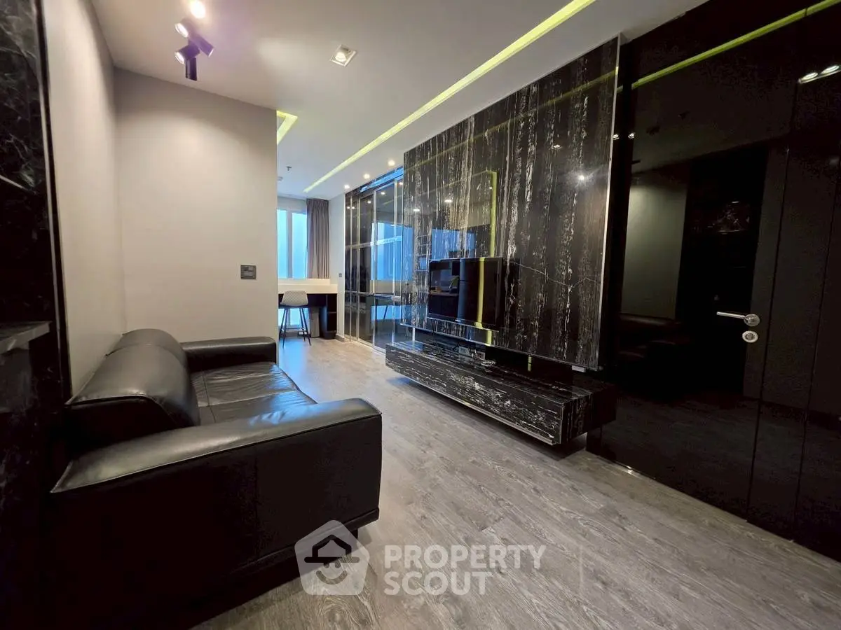 Luxurious modern living room with sleek black marble accents and stylish furnishings.