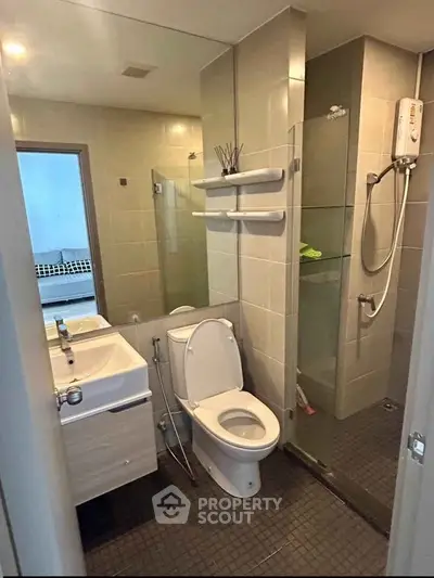 Modern bathroom with glass shower and sleek fixtures in a contemporary apartment.