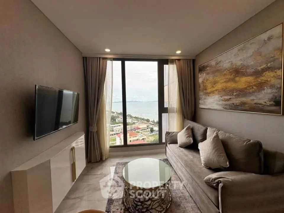 Luxurious living room with stunning sea view, modern decor, and elegant furnishings in a high-rise apartment.