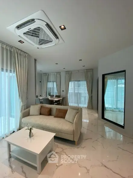 Luxurious modern living room with elegant decor and large windows