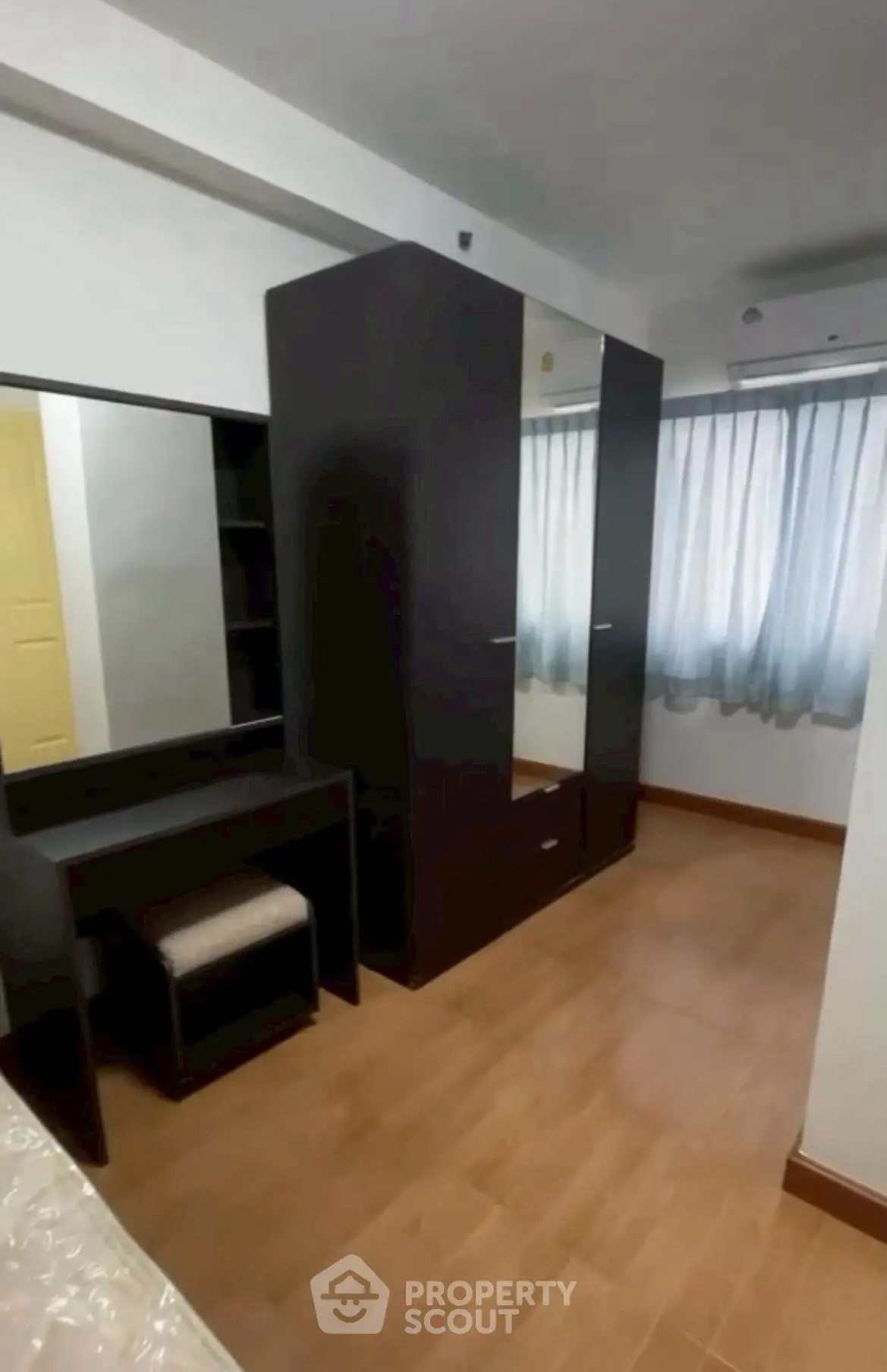 Spacious bedroom with modern wardrobe and natural light