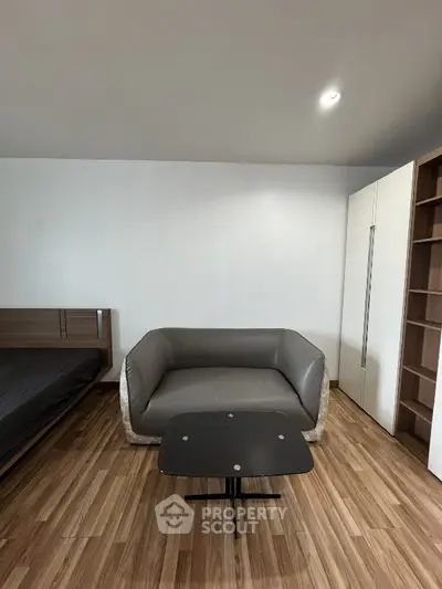 Modern living room with sleek furniture and wooden flooring