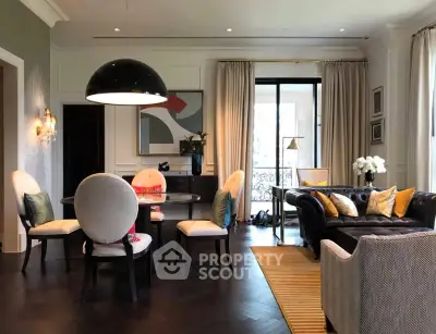 Luxurious living room with elegant decor and spacious seating area, featuring modern lighting and stylish furnishings.