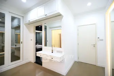 Elegant bedroom with built-in vanity and mirrored wardrobe