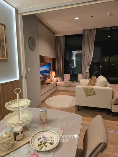 Elegant living room with cozy seating and city view, perfect for relaxation and entertainment.