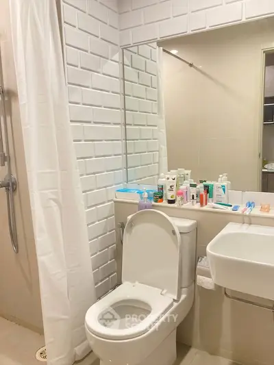 Modern bathroom with white tiles and sleek fixtures