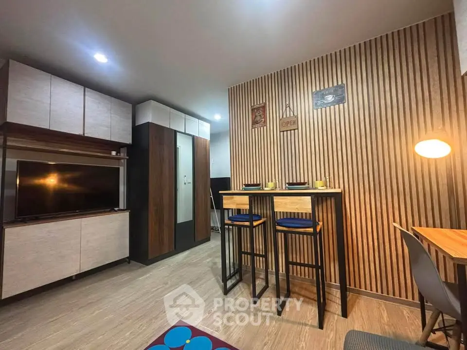 Modern living room with stylish wooden paneling and cozy dining area