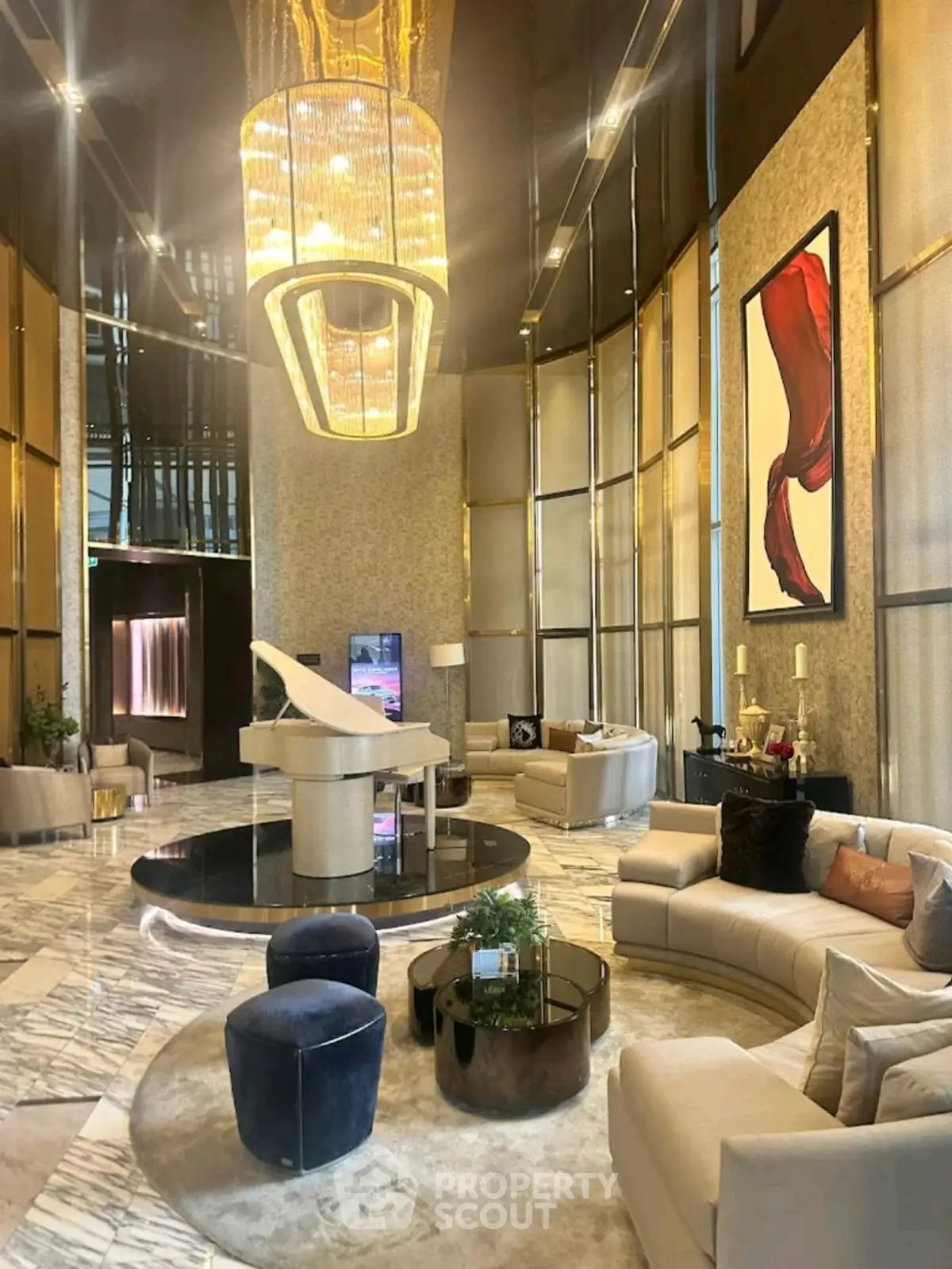 Luxurious living room with grand piano and elegant chandelier in upscale property.