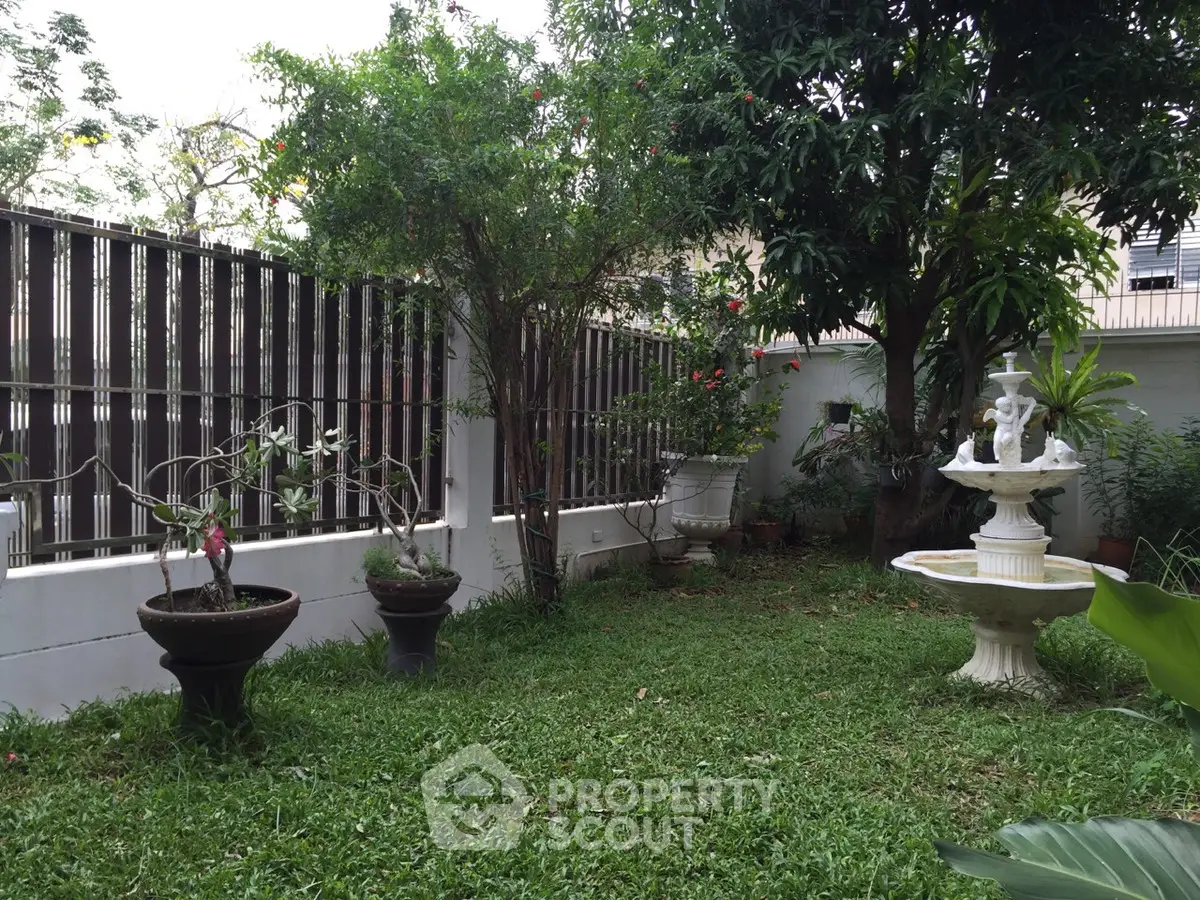 Charming garden with lush greenery and elegant fountain, perfect for relaxation and outdoor enjoyment.