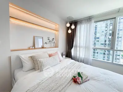 Bright and cozy bedroom with modern decor and large window view.