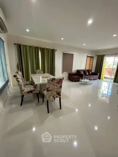 Spacious living room with elegant dining area and modern decor