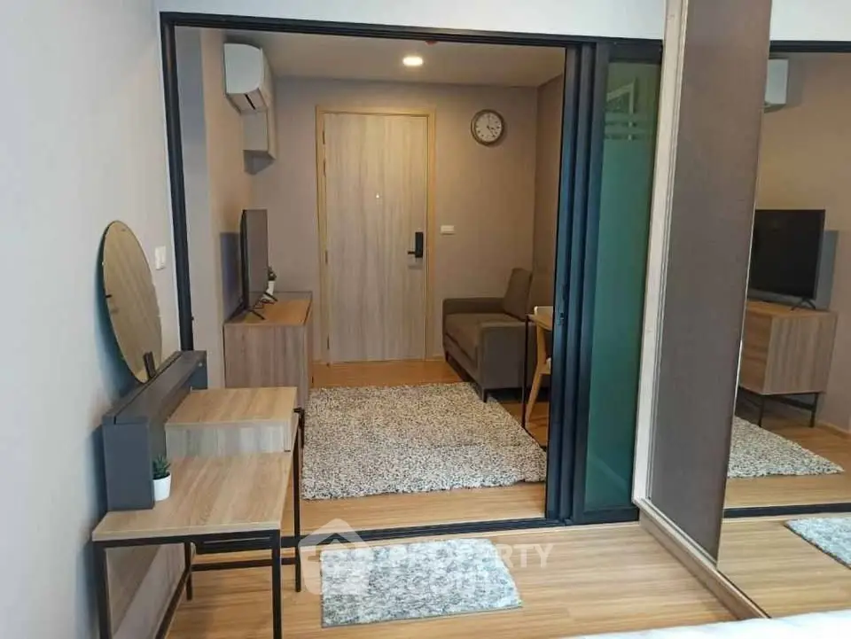 Modern studio apartment with stylish decor and open layout, featuring a cozy living area and sleek furnishings.