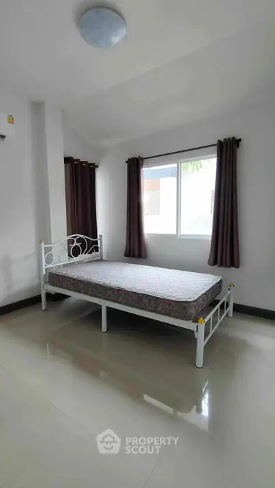 Spacious bedroom with natural light and minimalist decor