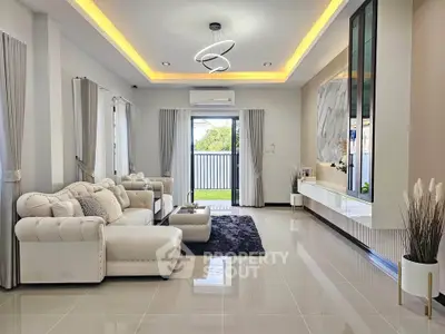 Luxurious modern living room with elegant lighting and plush white sofas