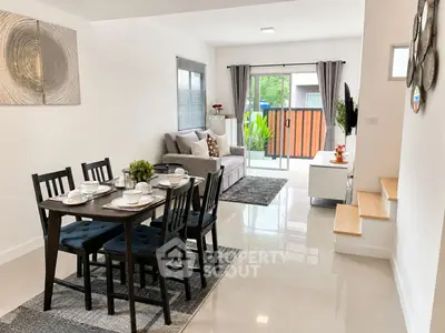 Modern open-plan living and dining area with stylish decor and natural light.