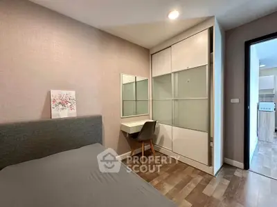 Modern bedroom with sleek furniture and built-in wardrobe