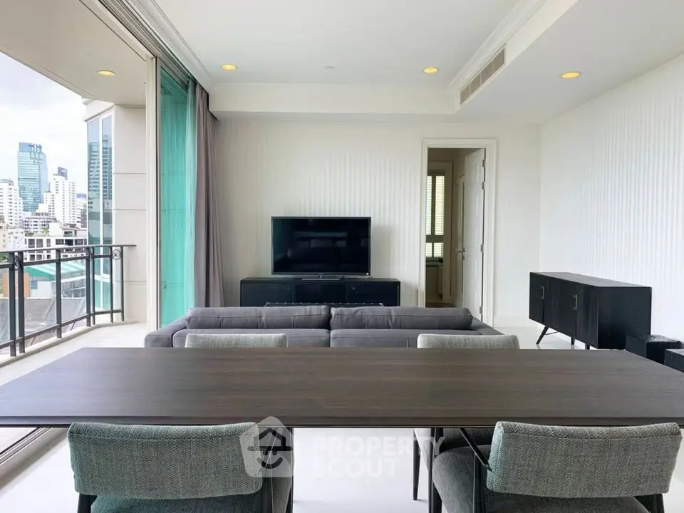 Spacious modern living room with city view and elegant furnishings.