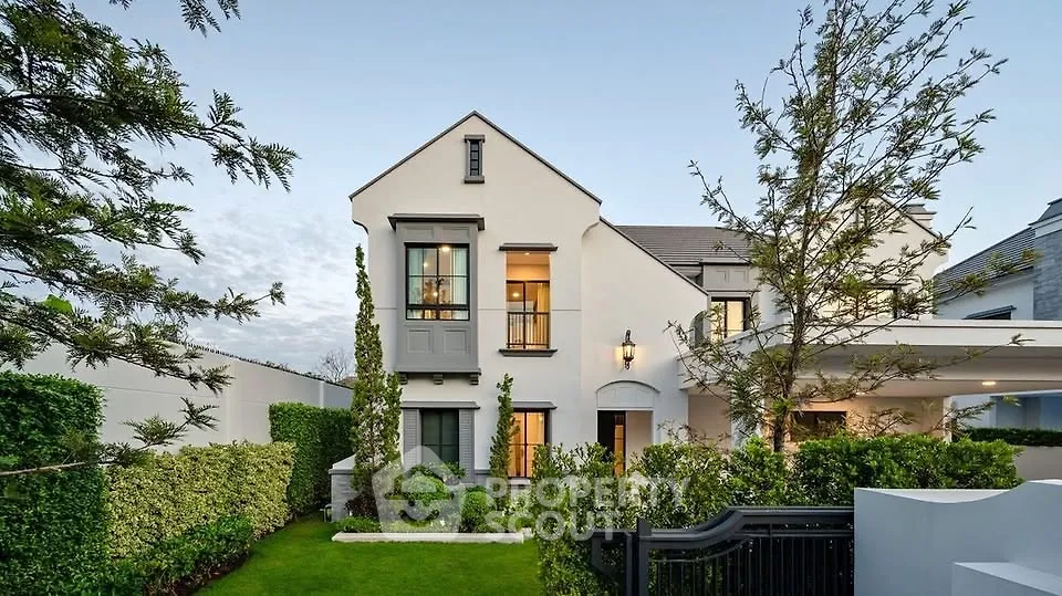 Elegant two-story home with manicured garden and modern architecture