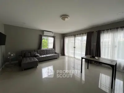Spacious living room with modern furniture and large windows for natural light.
