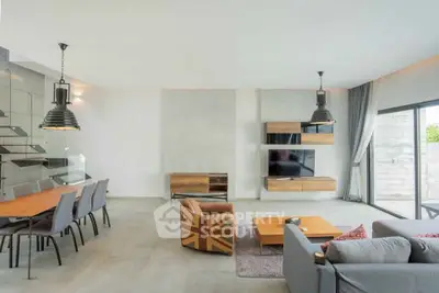 Spacious modern living room with stylish furniture and large windows for natural light.