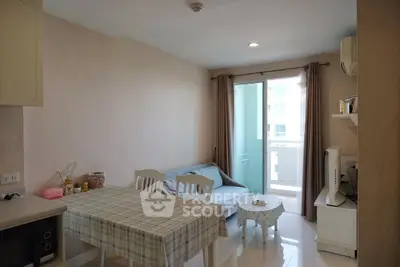 Cozy living room with dining area and balcony access in modern apartment