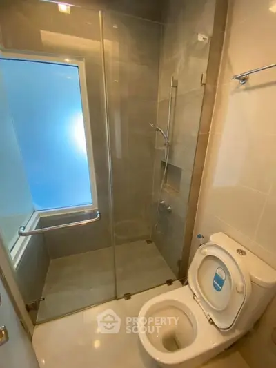 Modern bathroom with glass shower enclosure and sleek fixtures