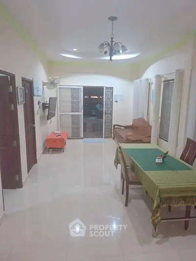 Spacious living room with elegant decor and ample natural light, perfect for family gatherings.