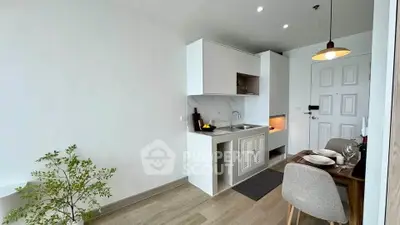 Modern compact kitchen with dining area in a stylish apartment