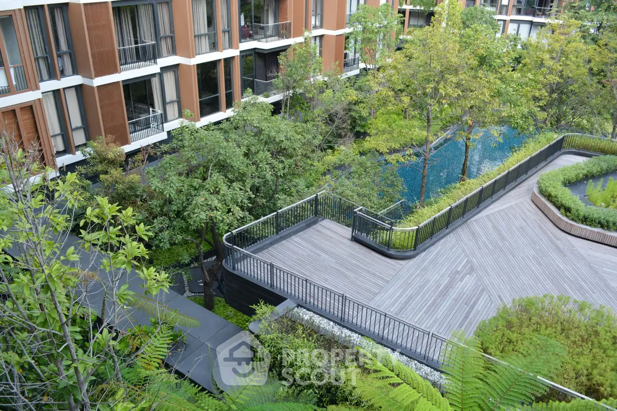 Luxurious residential building with lush garden and serene pool view