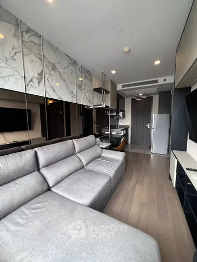 Modern living room with stylish decor and open kitchen layout in a contemporary apartment.