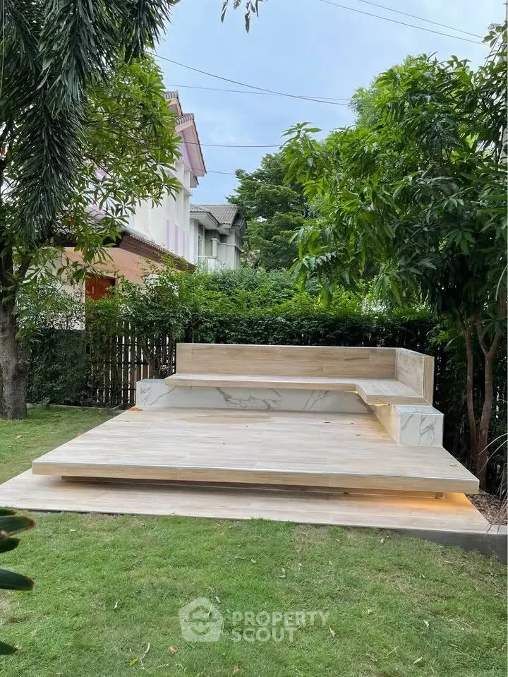 Elegant outdoor seating area in lush garden setting with modern design