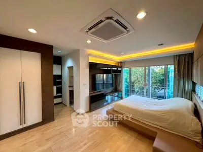 Spacious bedroom with modern design and large windows offering a serene view.