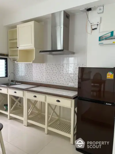 Bright and airy kitchen space featuring modern appliances, ample cabinetry, and elegant tile backsplash, perfect for culinary enthusiasts.