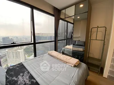 Modern bedroom with stunning city view and floor-to-ceiling windows