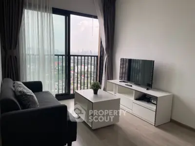 Modern living room with city view, sleek furniture, and large window for natural light.