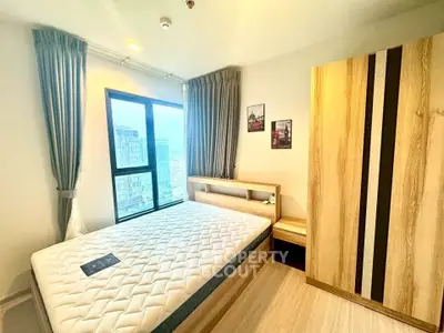 Modern bedroom with large window and stylish wooden furniture