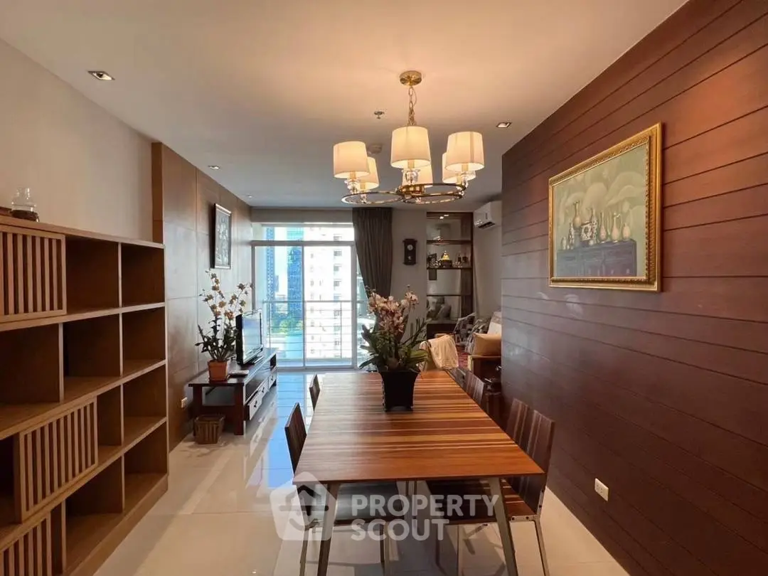 Elegant dining area with modern chandelier and wooden accents in a high-rise apartment.