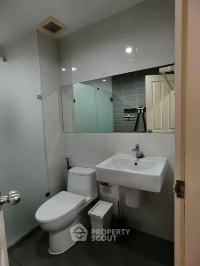 Modern bathroom with sleek fixtures and glass shower enclosure