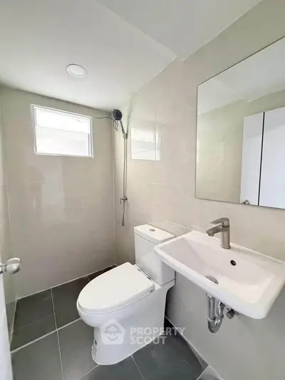 Modern bathroom with sleek fixtures and natural light, perfect for a contemporary home.