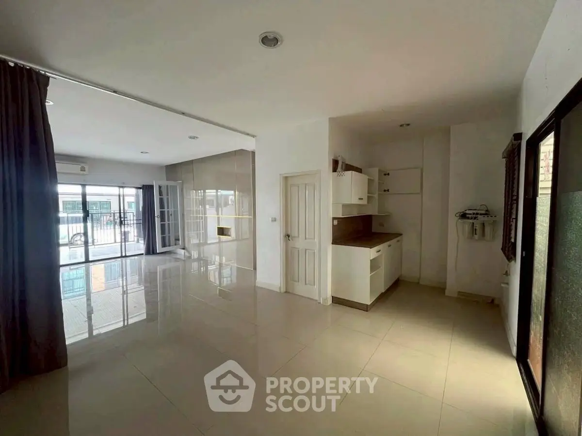 Spacious open-plan living area with modern kitchen and large windows