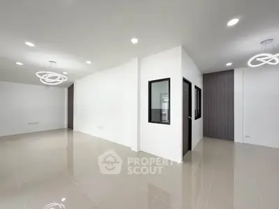 Spacious modern interior with sleek lighting and glossy tiled floors