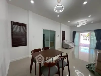 Spacious modern living room with dining area and large windows for natural light.