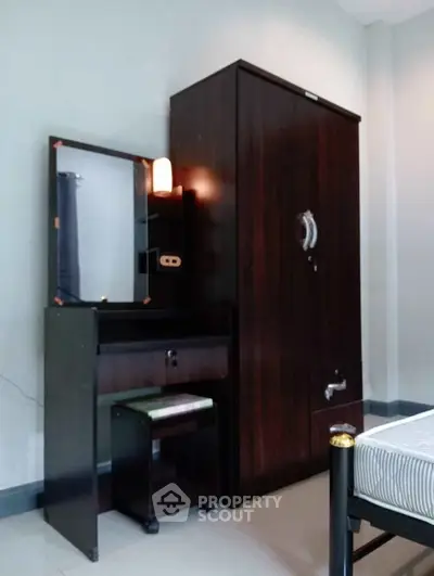 Cozy bedroom with elegant dark wood furniture and sleek design