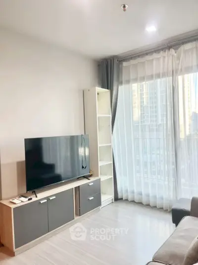 Modern living room with sleek TV setup and city view