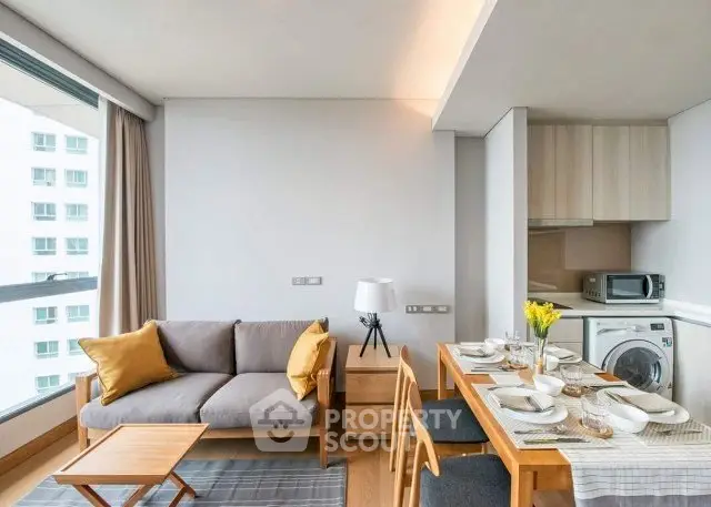 Modern living room with dining area and large window in a stylish apartment