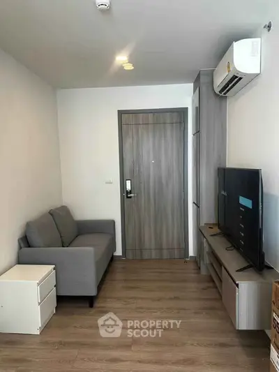 Cozy living room with modern furniture and air conditioning in a compact apartment.