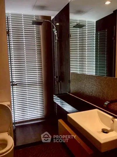 Modern bathroom with sleek fixtures and stylish blinds